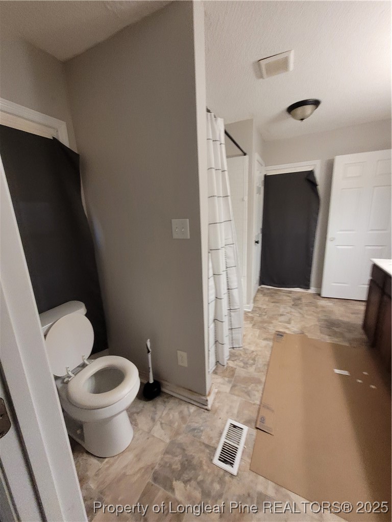 599 Haws Run Road Jacksonville, NC 28540 - Photo 27 of 43 a bathroom with a toilet and a shower