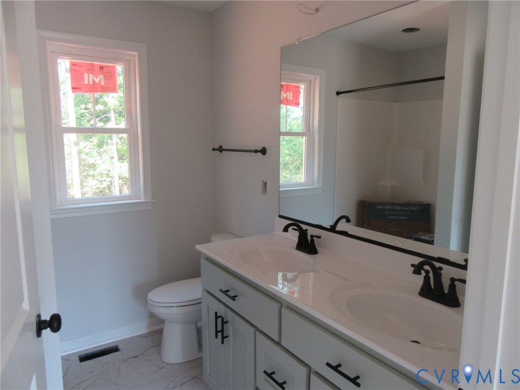 Lot 5 White Oak Church Road Wilsons, VA 23894 - Photo 13 of 17 a bathroom with a sink toilet and vanity