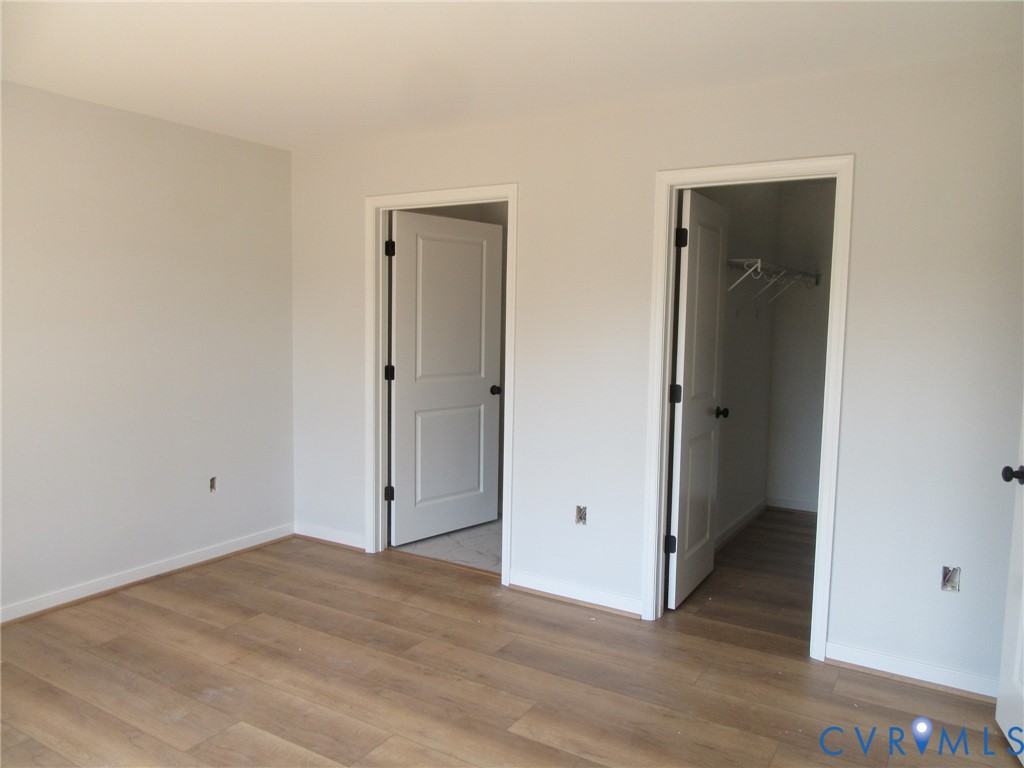 10314 White Oak Church Road Wilsons, VA 23894 - Photo 15 of 21 an empty room with wooden floor and closet