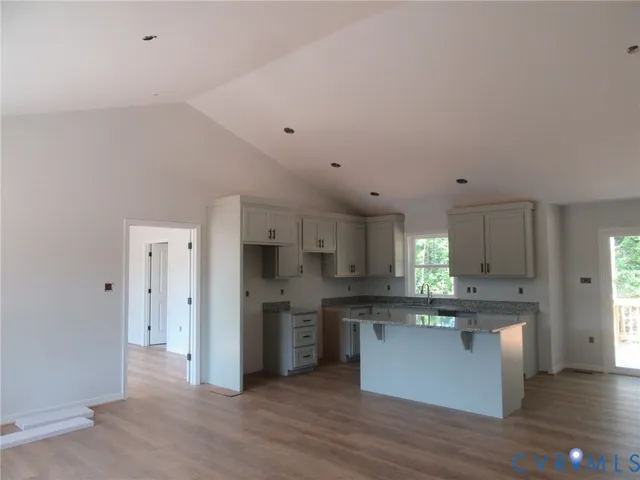 a kitchen with stainless steel appliances a refrigerator and a stove top oven