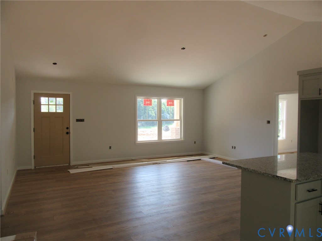 Lot 5 White Oak Church Road Wilsons, VA 23894 - Photo 8 of 17 an empty room with wooden floor and windows
