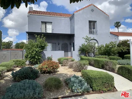 a view of a house with a yard and plants