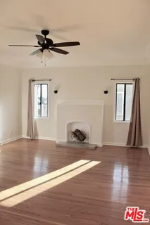 a view of an empty room and wooden floor