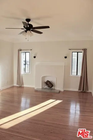 a view of an empty room and wooden floor