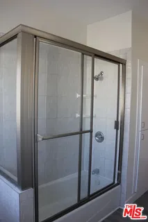 a bathroom with a glass shower door