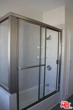 a bathroom with a glass shower door