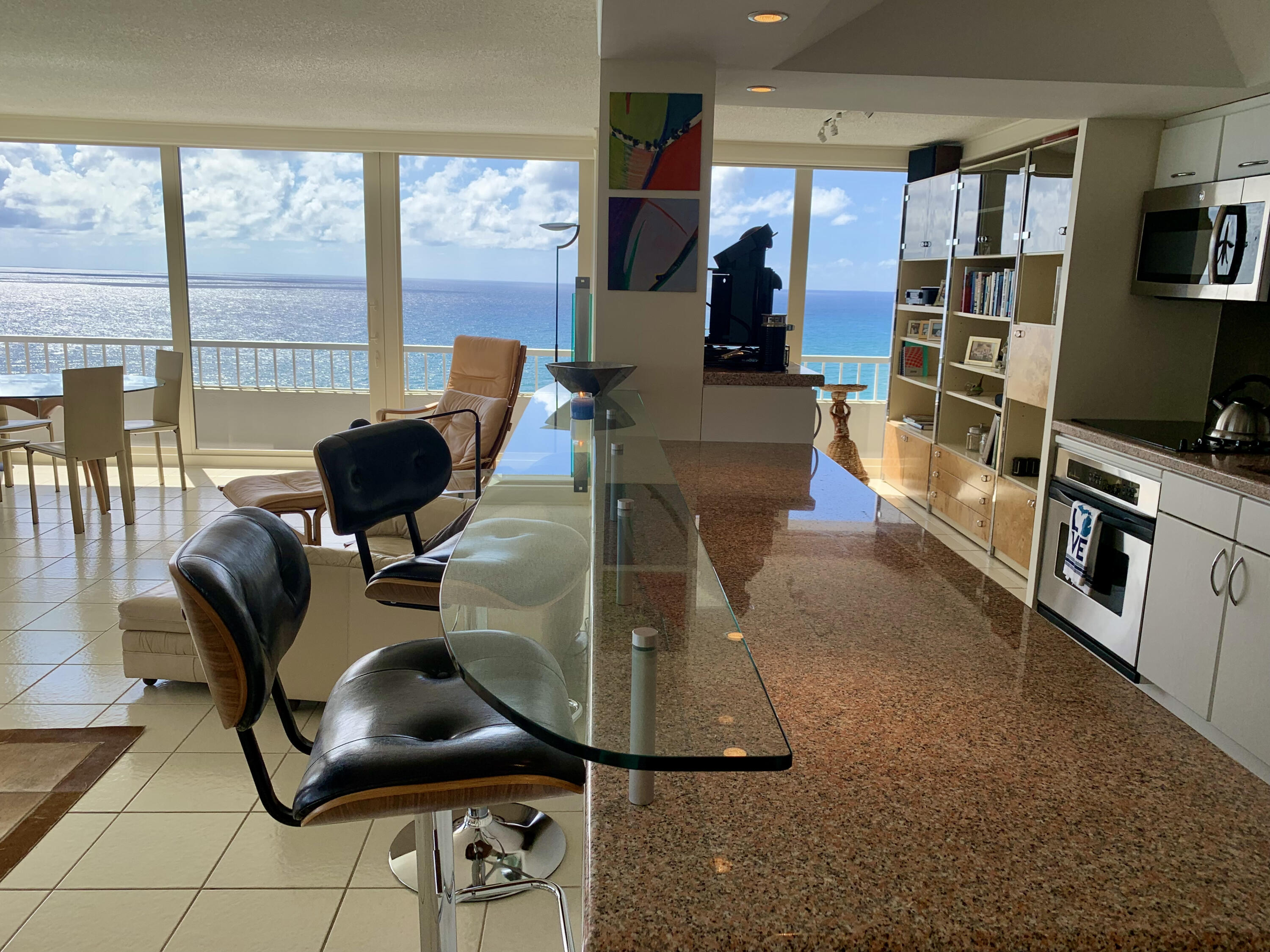 5540 North Ocean Drive, Unit PHA Riviera Beach, FL 33404 - Photo 13 of 42 a living room with furniture a flat screen tv and a floor to ceiling window