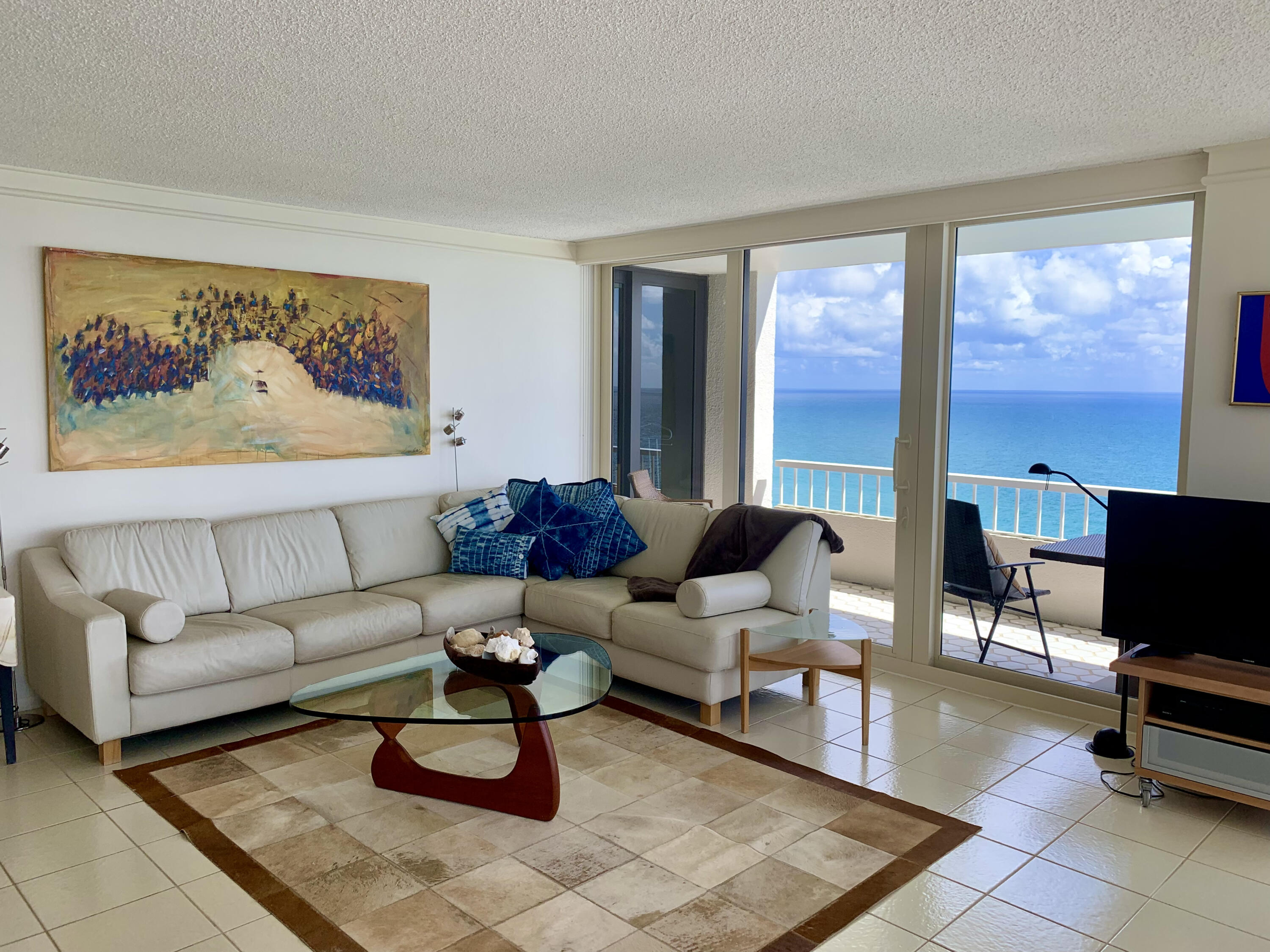 5540 North Ocean Drive, Unit PHA Riviera Beach, FL 33404 - Photo 2 of 42 a living room with furniture a rug and a large window