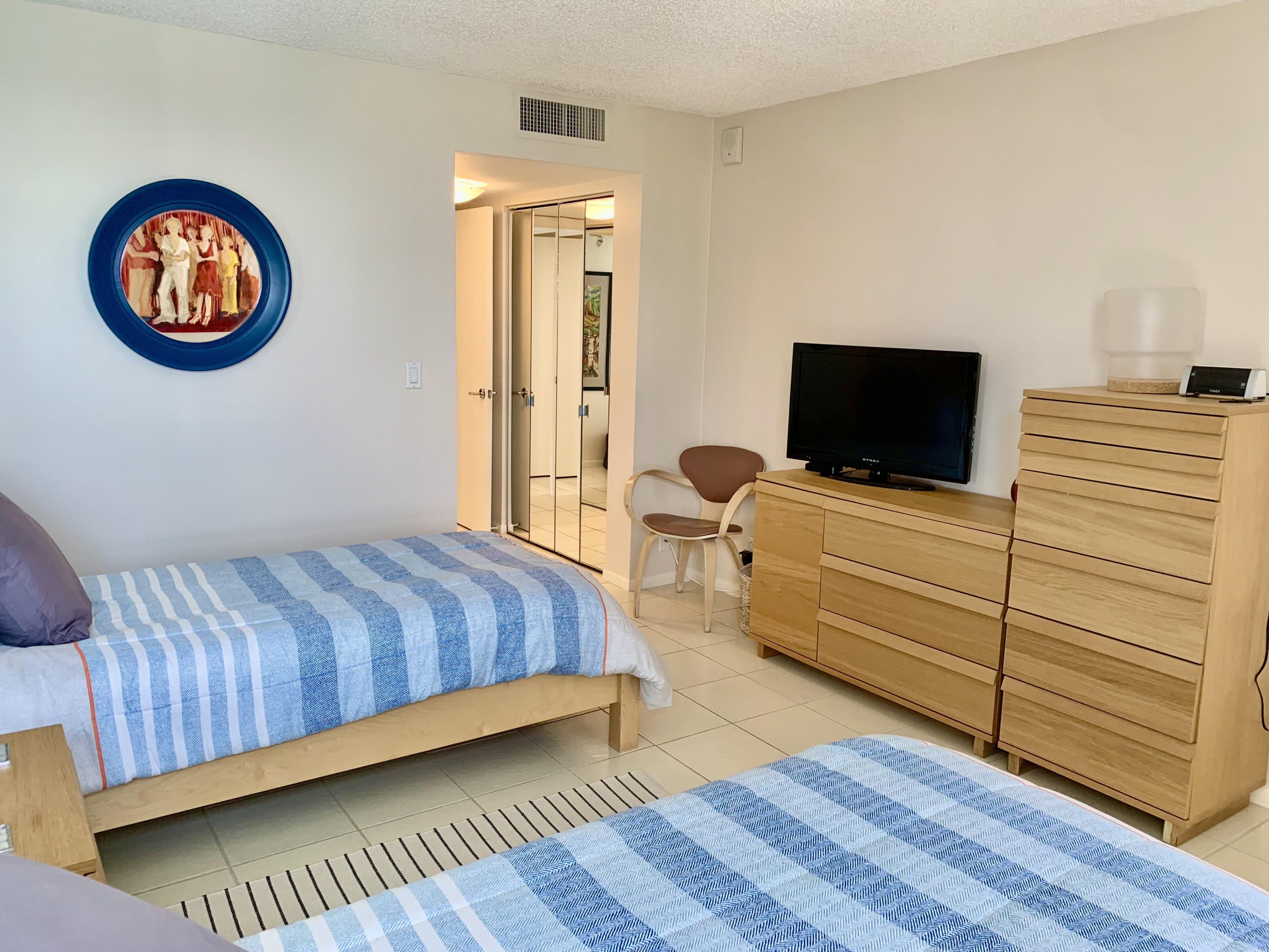 5540 North Ocean Drive, Unit PHA Riviera Beach, FL 33404 - Photo 22 of 42 a bedroom with a bed and a flat screen tv