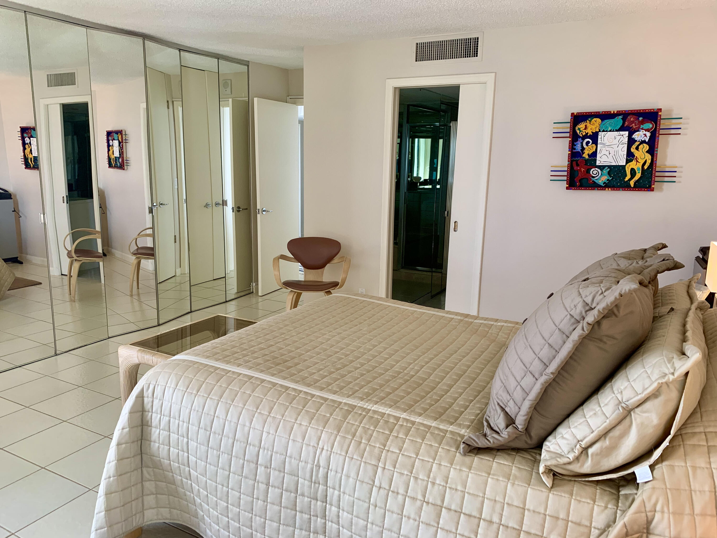 5540 North Ocean Drive, Unit PHA Riviera Beach, FL 33404 - Photo 26 of 42 a bedroom with a bed and a painting on the wall