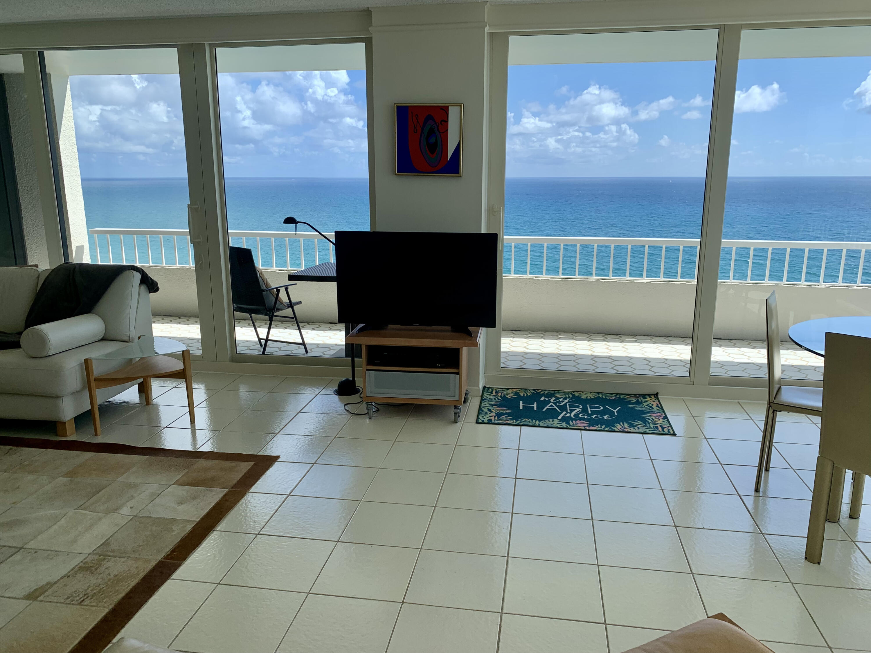 5540 North Ocean Drive, Unit PHA Riviera Beach, FL 33404 - Photo 3 of 42 a living room with furniture and a flat screen tv