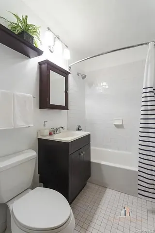 a bathroom with a sink a mirror toilet and bathtub