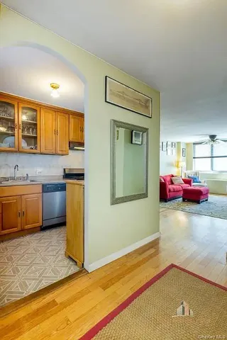 a bedroom with a bed and a view of kitchen