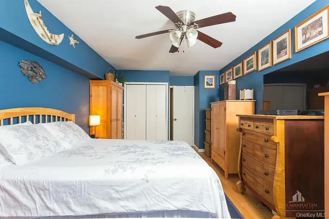 a spacious bedroom with a bed and a flat screen tv