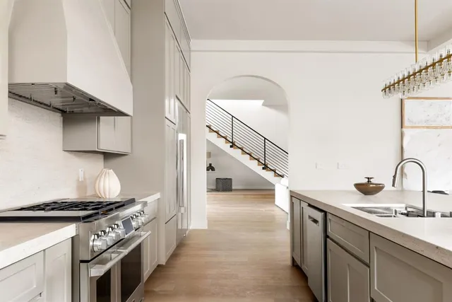 a kitchen with a sink stove and cabinets