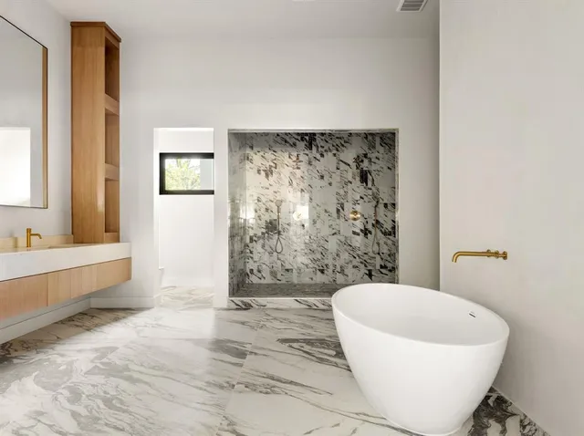 a bathroom with a bathtub and shower