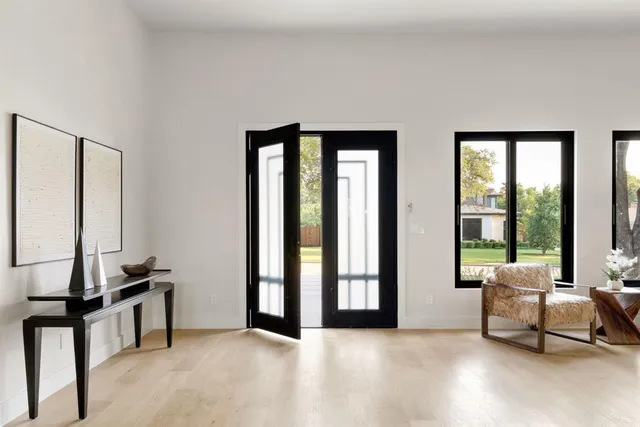 a living room with furniture and large windows
