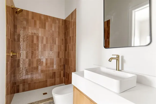 a bathroom with a sink toilet and shower