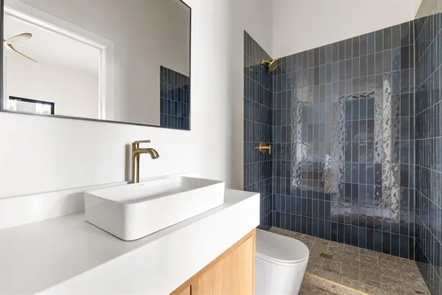 a bathroom with a sink toilet and shower