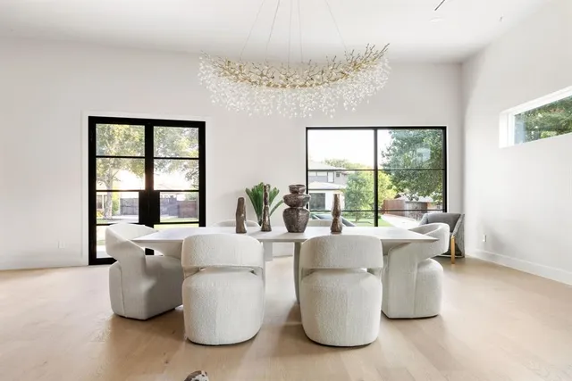 a living room with furniture and large windows