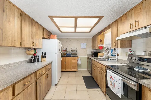 a kitchen with a sink stove and cabinets