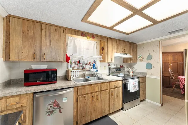 a kitchen with a sink stove and cabinets