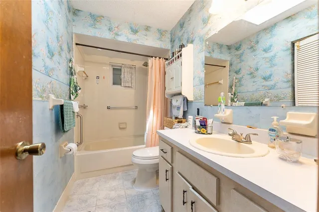 a bathroom with a sink toilet tub and shower