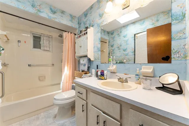 a bathroom with a sink toilet tub and shower