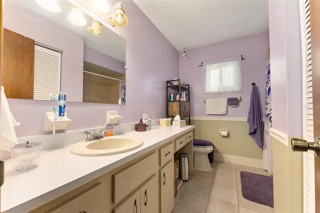 a bathroom with a sink double vanity granite tub shower and a mirror