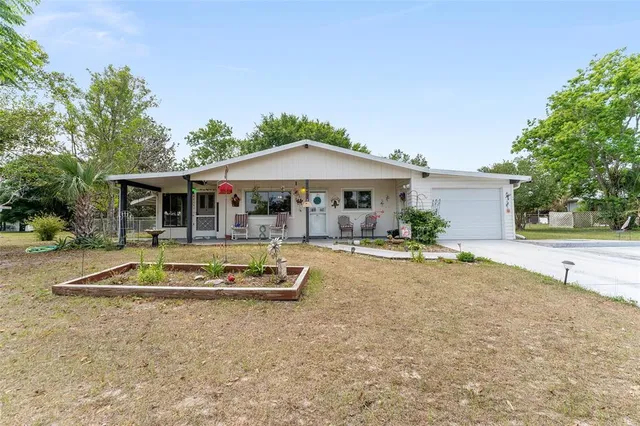 a front view of house with swimming pool and porch with furniture