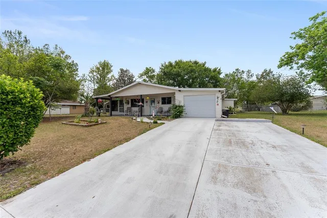 a view of a patio with a table and chairs under an umbrella