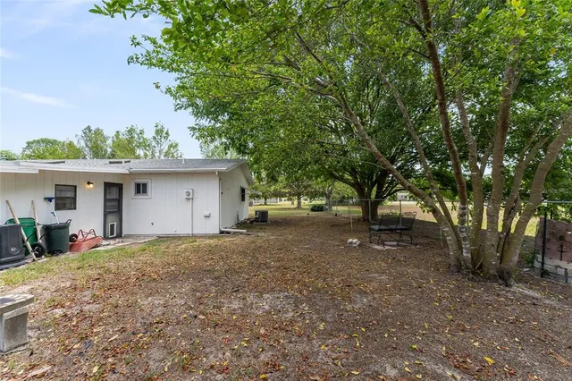 a view of a house with a tree in the background
