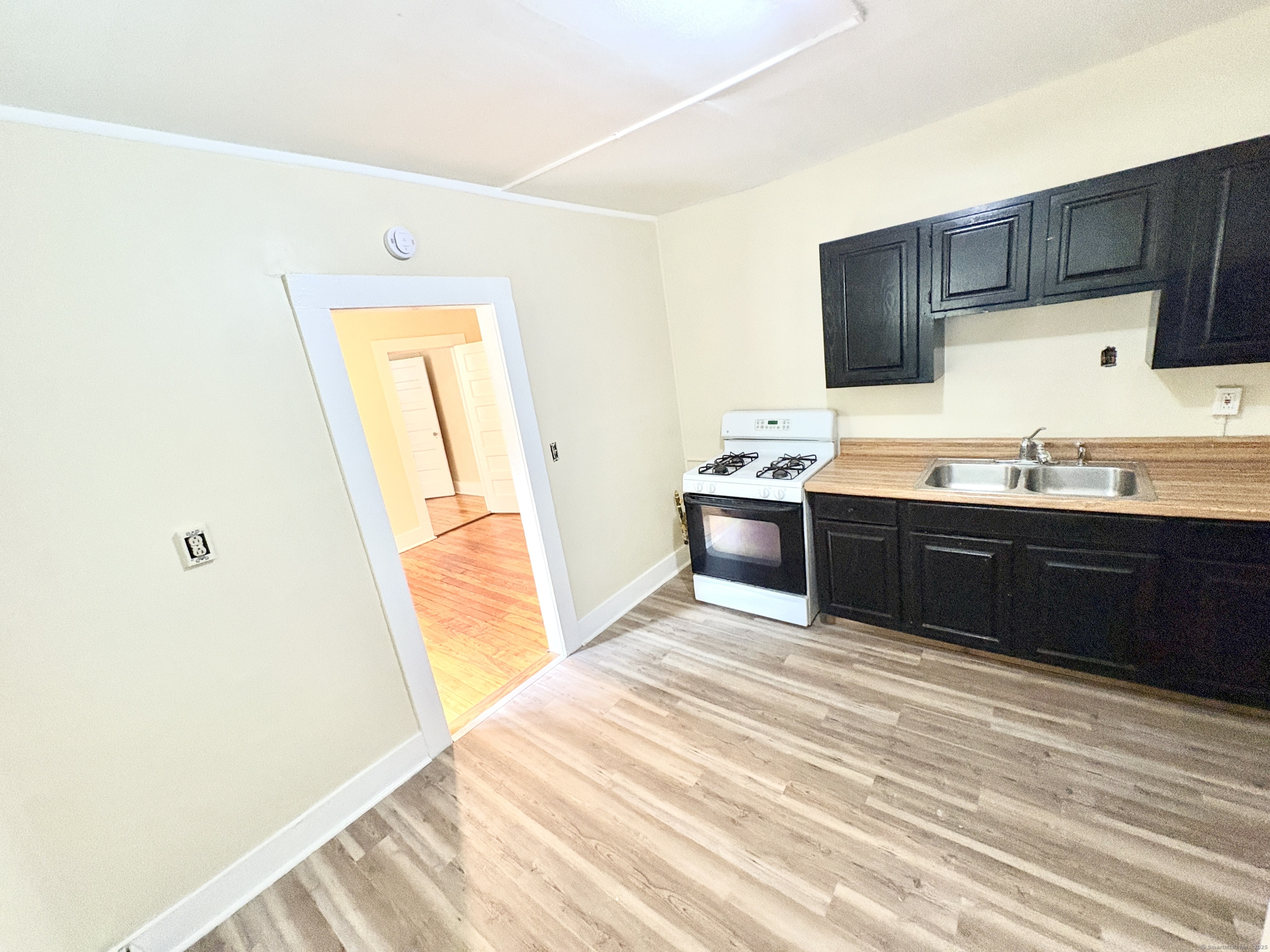 1019 West Main Street, Unit 3R Waterbury, CT 06708 - Photo 12 of 25 a kitchen with stainless steel appliances granite countertop a sink and a stove