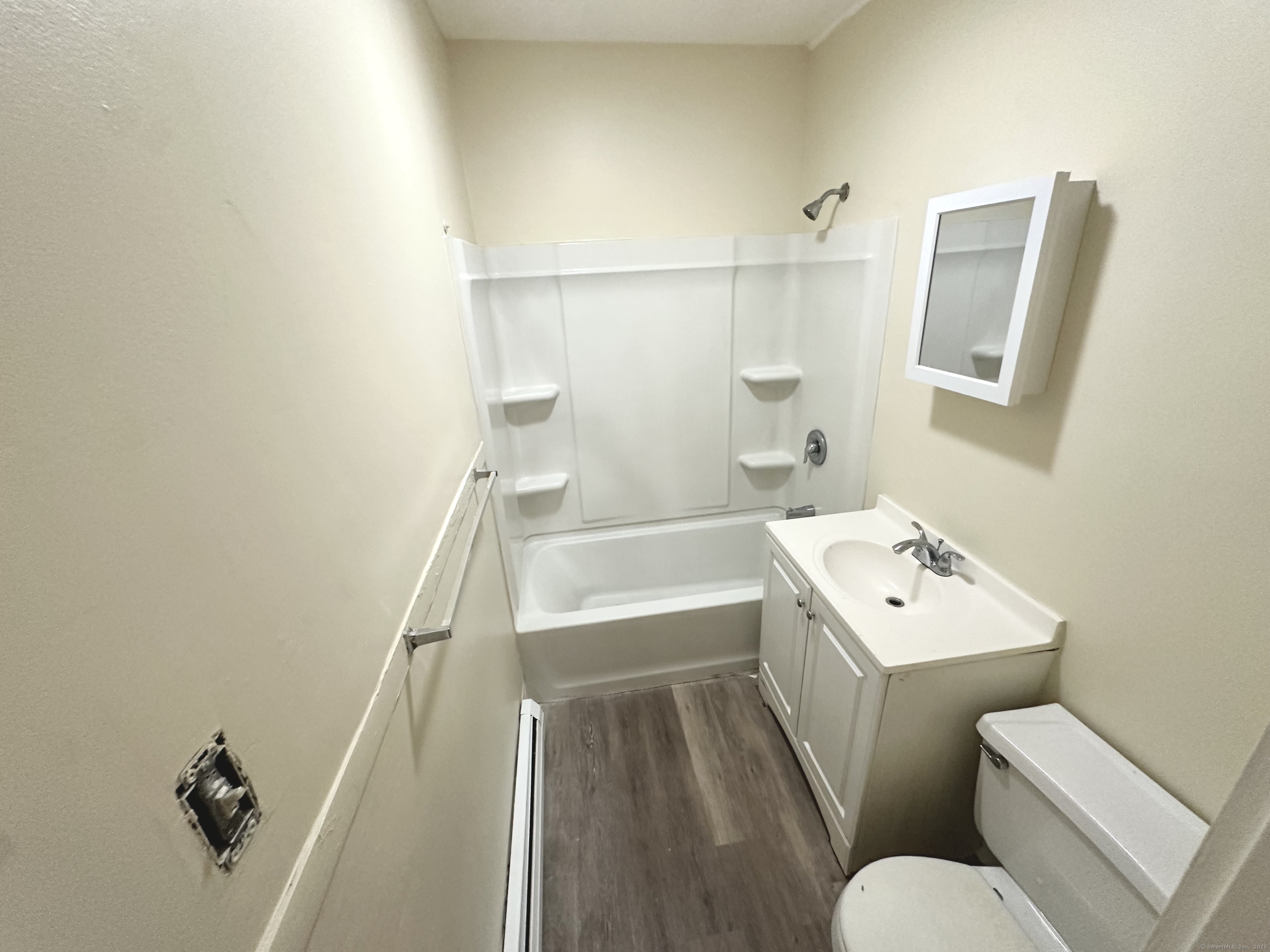 1019 West Main Street, Unit 3R Waterbury, CT 06708 - Photo 16 of 25 a bathroom with a sink toilet vanity and tub
