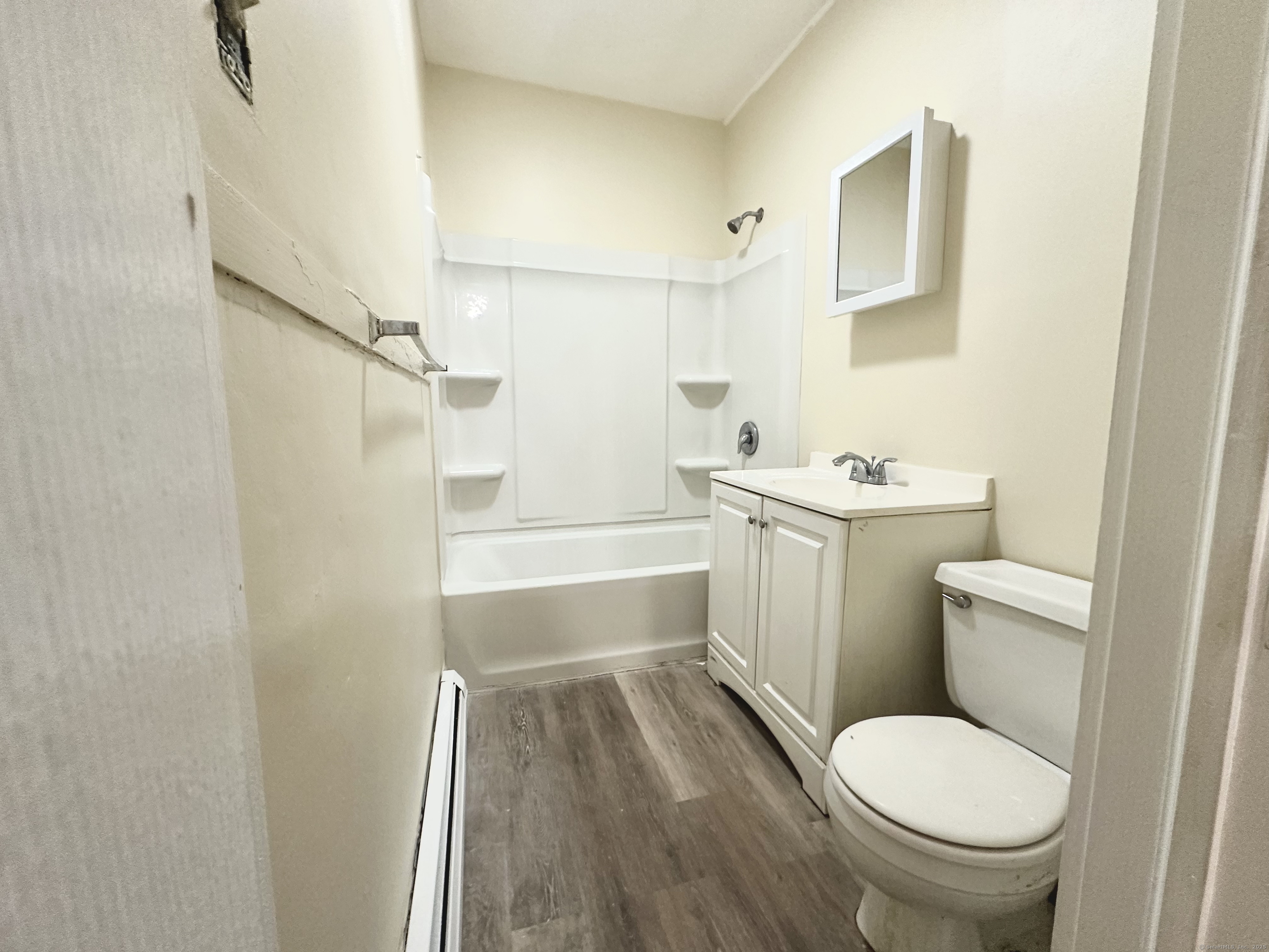 1019 West Main Street, Unit 3R Waterbury, CT 06708 - Photo 18 of 25 a bathroom with a toilet a sink and a bathtub