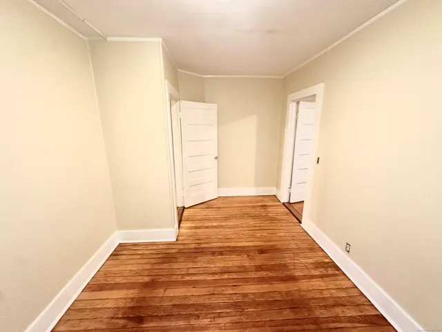 a view of a room with wooden floor