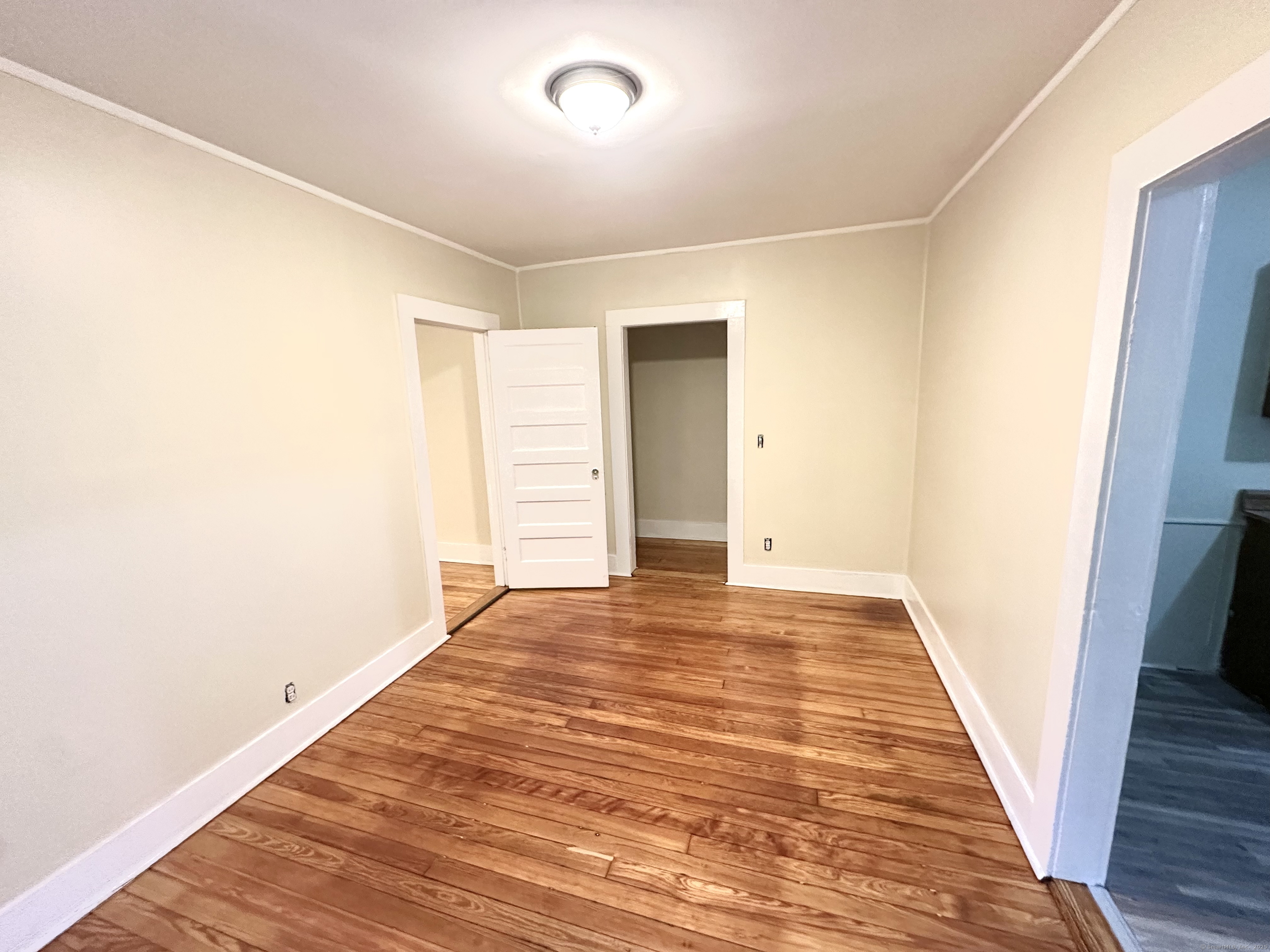 1019 West Main Street, Unit 3R Waterbury, CT 06708 - Photo 10 of 25 a view of an empty room with wooden floor