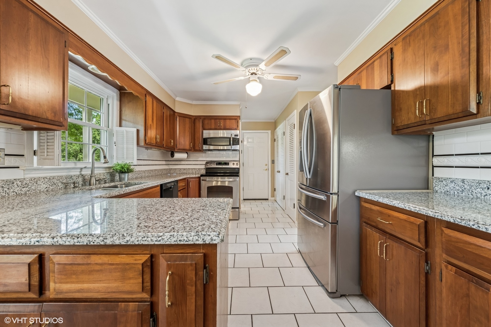 143 Firth Road Inverness, IL 60067 - Photo 7 of 31 a kitchen with stainless steel appliances granite countertop a refrigerator a stove and a sink with wooden cabinets