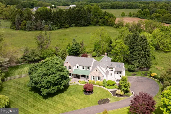 an aerial view of residential houses with outdoor space and lake view