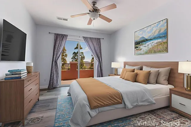 a bedroom with a large bed and a flat screen tv