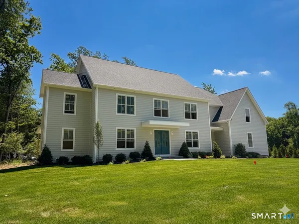 a front view of house with yard and green space