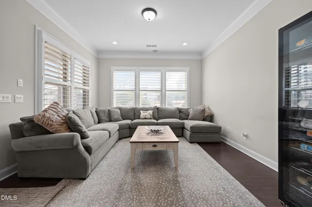 a dining room with furniture window and wooden floor