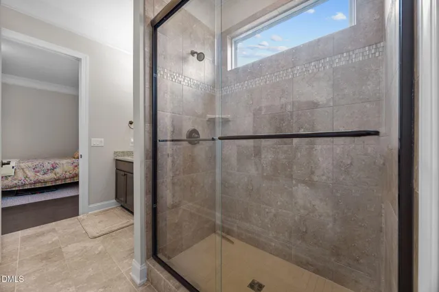 a bed sitting in a bedroom next to a window