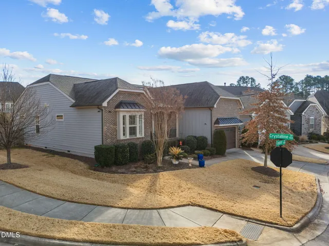 a view of a house with a yard and wooden fence