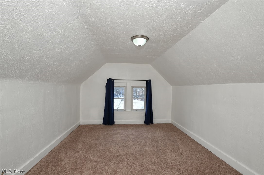77 West Mildred Avenue Akron, OH 44310 - Photo 31 of 40 Bonus room featuring carpet floors and a textured ceiling