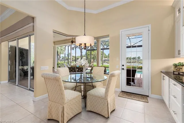 a dining room with furniture a chandelier and window