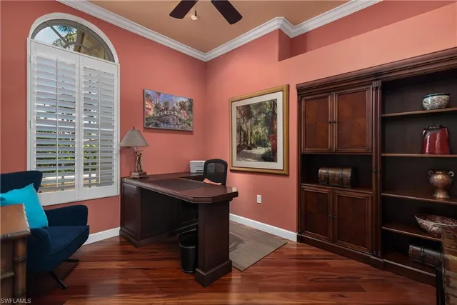 a view of a workspace with furniture and a window