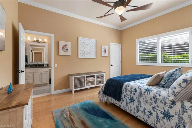a bedroom with a bed and dresser with wooden floor