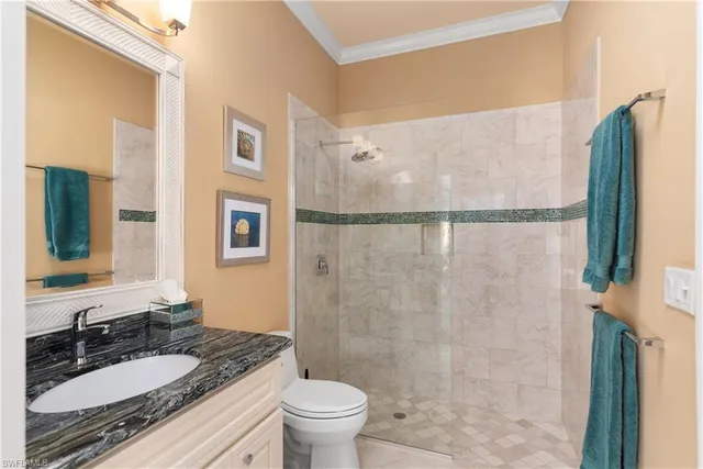 a bathroom with a granite countertop sink toilet and shower