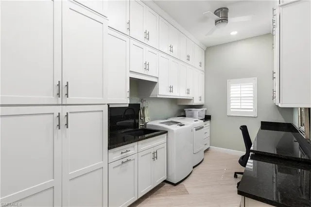 a kitchen with cabinets appliances a sink and a window